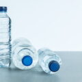 hd wallpaper premium three plastic bottles filled with mineral water on white background